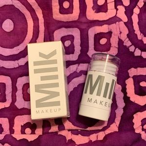 Milk Creamy Pearlescent highlighter stick in lit